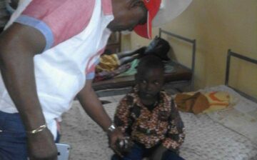 Senator Kupee making a follow-up visit to a child he transferred to a hospital in Voinjama. The child’s hands were badly burned by his angry mother for stealing LD 50 (less than US$0.50 ) to buy food during recess.