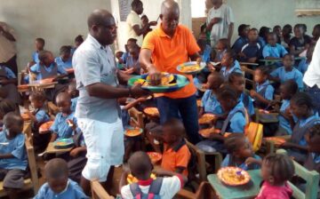 Senator Kupee and team distributing food at a school feeding program in Voinjama City, Lofa county.